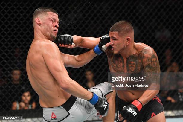 Anthony Pettis punches Nate Diaz in their welterweight bout during the UFC 241 event at the Honda Center on August 17, 2019 in Anaheim, California.