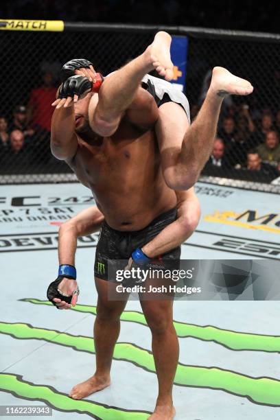 Daniel Cormier takes down Stipe Miocic in their heavyweight championship bout during the UFC 241 event at the Honda Center on August 17, 2019 in...