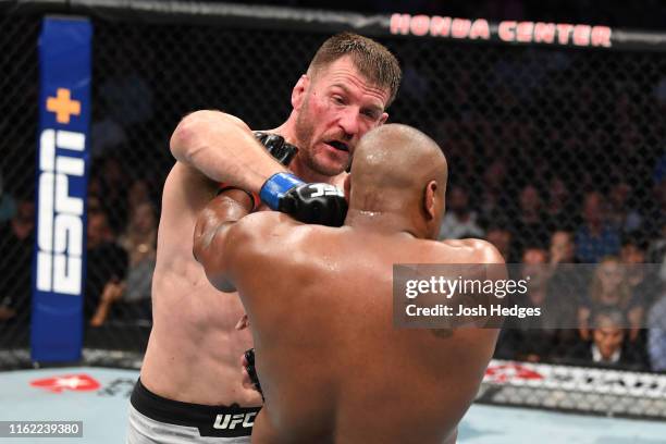 Stipe Miocic punches Daniel Cormier in their heavyweight championship bout during the UFC 241 event at the Honda Center on August 17, 2019 in...