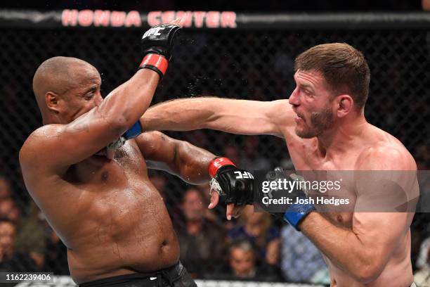 Stipe Miocic punches Daniel Cormier in their heavyweight championship bout during the UFC 241 event at the Honda Center on August 17, 2019 in...