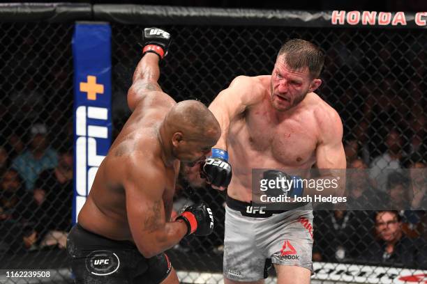 Stipe Miocic punches Daniel Cormier in their heavyweight championship bout during the UFC 241 event at the Honda Center on August 17, 2019 in...