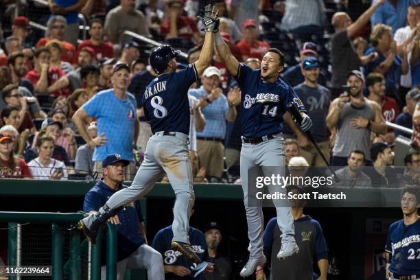 Ryan Braun of the Milwaukee Brewers celebrates with Hernan Perez after hitting a home run during the ninth inning at Nationals Park on August 17,...