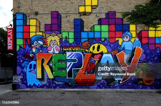 Stuk1 and Amuse126's 'Replay' mural is displayed outside Replay Beer and Bourbon in the Boystown Lakeview neighborhood in Chicago, Illinois on July...