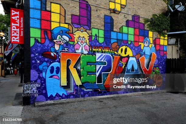 Stuk1 and Amuse126's 'Replay' mural is displayed outside Replay Beer and Bourbon in the Boystown Lakeview neighborhood in Chicago, Illinois on July...