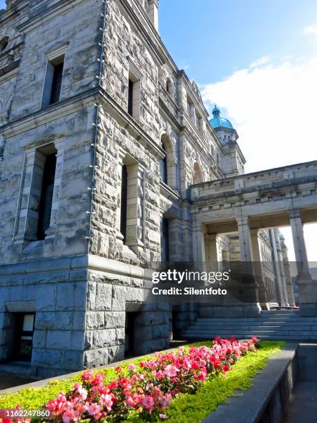 flowerbed outside british columbia parliament building on sunny day - british columbia legislature stock pictures, royalty-free photos & images