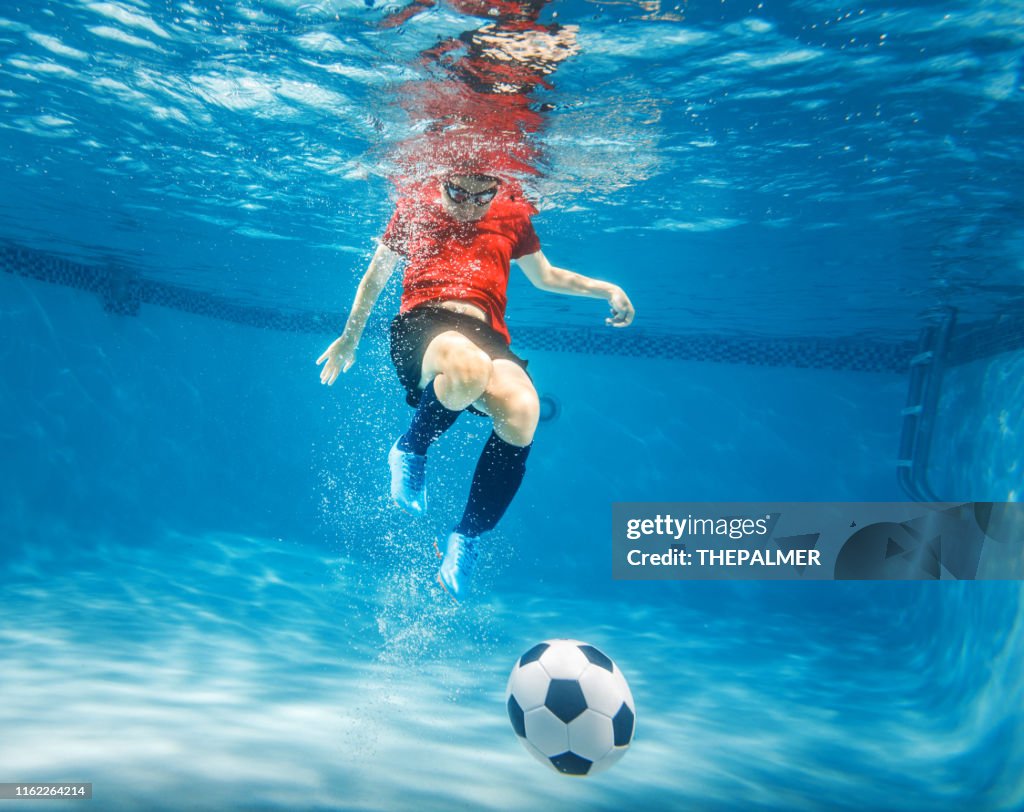 Kid underwater soccer