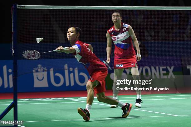 Yuta Watanabe and Arisa Higashino of Japan compete against Chris Adcock and Gabrielle Adcock of England on day one of the Bli Bli Indonesia Open at...