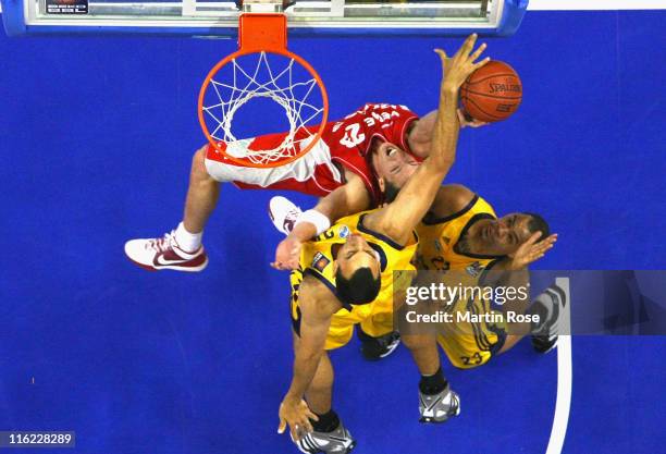 Casey Jacobsen of Bamberg tries to score over Lucca Staiger and Immanuel McElroy of Berlin during the Beko BBL Playoffs Final game four between Alba...