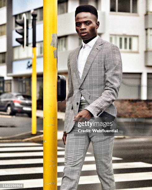 Young black man in suit walking on the streets of Cape Town