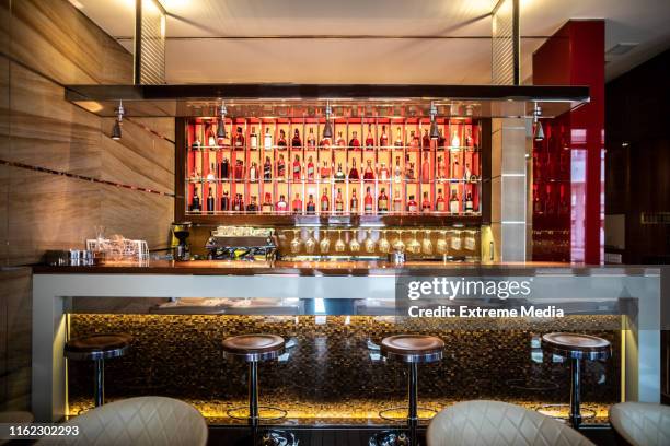 a bar with stools and drinks shelf in a modern restaurant - vip bar stock pictures, royalty-free photos & images