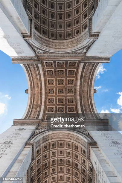 low angle image of arc de triomphe de l'étoile, paris, france - de paris stock pictures, royalty-free photos & images