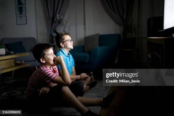 boys watching a movie at home at night - home movie stock pictures, royalty-free photos & images