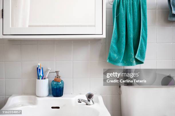 tooth brush cup and soap dispenser in a washroom - toiletries stock pictures, royalty-free photos & images