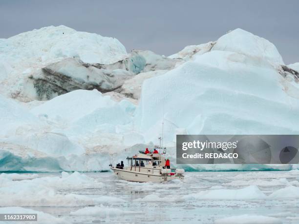 Exkursion boat with tourists. Ilulissat Icefjord also called kangia or Ilulissat Kangerlua at Disko Bay. The icefjord is listed as UNESCO world...