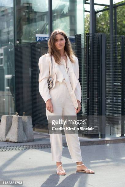 Art director Marie Camille Denjean wears a Mugler jacket, Paco Rabanne bag, Ancient Greek sandals and vintage trousers and shirt on June 30, 2019 in...