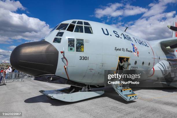 Lockheed Martin C-130 propeller military aircraft with special equipment for landing on glacier, ice or snow in arctic expedition and mission with...