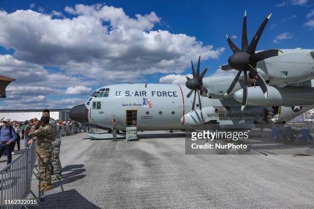 Lockheed Martin C-130 propeller military aircraft with special equipment for landing on glacier, ice or snow in arctic expedition and mission with...