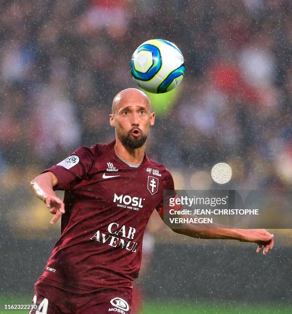 Metz' French midfielder Renaud Cohade eyes the ball during the French L1 football match between Metz and Monaco at Saint Symphorien stadium in...