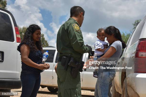 Two young mothers from Honduras, L and R, and their respective children - a 12-year-old, blocked, and 1-year-old - are detained by United States...