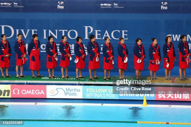 The Japanese team stands for the national anthem prior to their Women's Water Polo Preliminary match against Italy on day four of the Gwangju 2019...