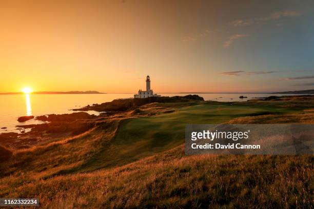 Graduated colour filter used on this image; A view of the par 3, ninth green as the sun sets over the Island of Arran on the Ailsa Course at the...