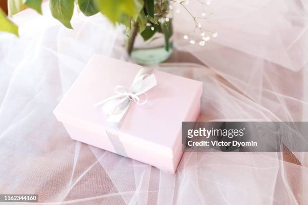 the box with a bow lies on tulle - gift ストックフォトと画像