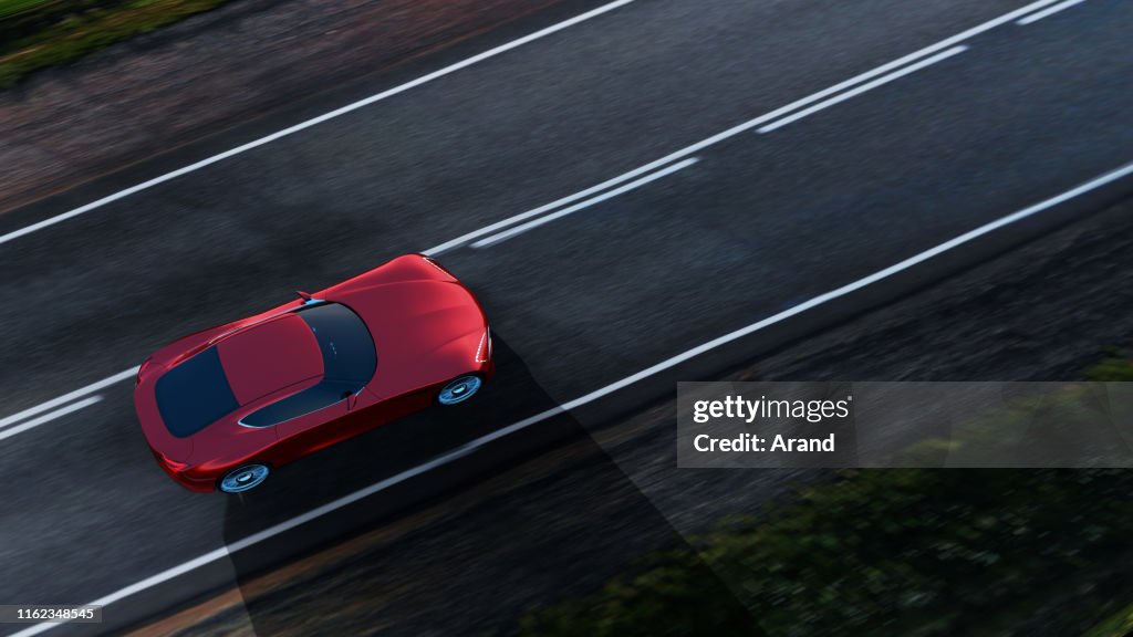 Carro vermelho que conduz em uma estrada