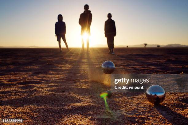 pétanque balls game on - pétanque stock pictures, royalty-free photos & images