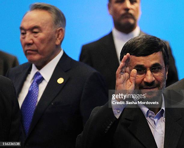 Iran's President Mahmoud Ahmadinejad and Kazakh President Nursultan Nazarbayev arrive to attend a trilateral meeting during the SCO Summit on June...