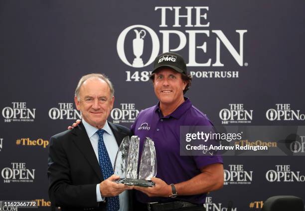 Official World Golf Ranking Chairman Peter Dawson presents Phil Mickelson of The United States with an award for spending the last 25 years in the...