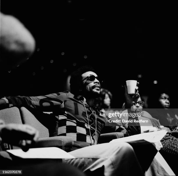 American record producer, multi-instrumentalist, singer, and film producer Quincy Jones sitting in the public on set of 'We Love You Madly', the Duke...