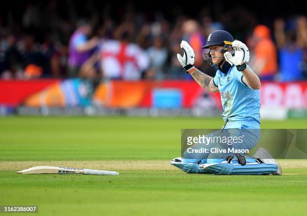 Ben Stokes of England apologises to New Zealand as the fielded ball hits his bat and runs away for four runs during the Final of the ICC Cricket...
