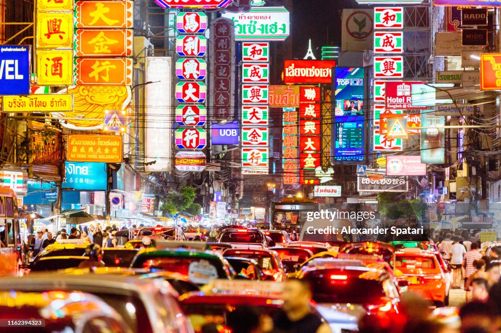 Neon signs and traffic lights at night in Chinatown, Bangkok, Thailand
