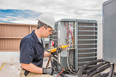 Hvac Tech working on a condensing unit