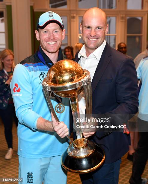 England captain Eoin Morgan and Andrew Strauss celebrate with the trophy after winning the Final of the ICC Cricket World Cup 2019 between New...