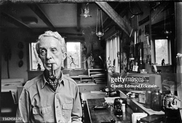 Portrait of American artist Norman Rockwell , a pipe in his mouth, as he poses in his studio, Stockbridge, Massachusetts, September 10, 1975.
