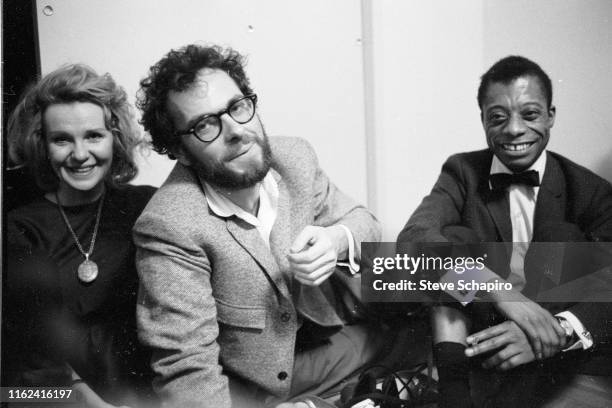 View of, from left, married American actors Geraldine Page and Rip Torn , and author & activist James Baldwin as they sit together on the floor...