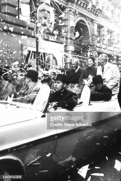 View of American astronaut John H Glenn Jr , his wife, Annie Glenn , and US Vice President Lyndon Baines Johnson as they ride in a convertible during...