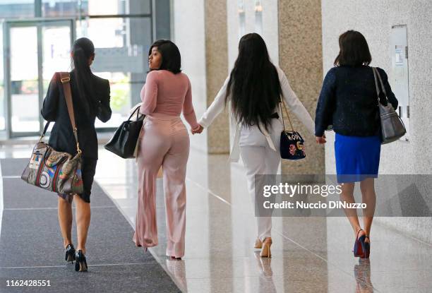 Center, supporters of singer R. Kelly, Joycelyn Savage and Azriel Clary and their attorneys arrive for the arraignment of the singer at the Dirksen...