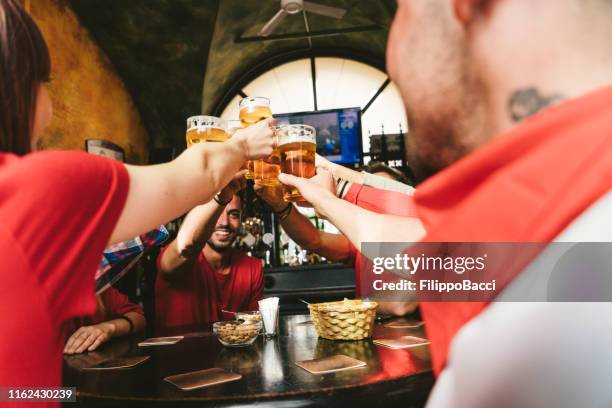 group of happy friends drinking beer at the brewery - irish pub stock pictures, royalty-free photos & images