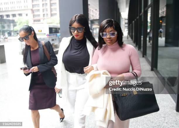 Supporters of singer R. Kelly, Azriel Clary and Joycelyn Savage, leave after the singer's arraignment at the Dirksen Federal Building on July 16,...