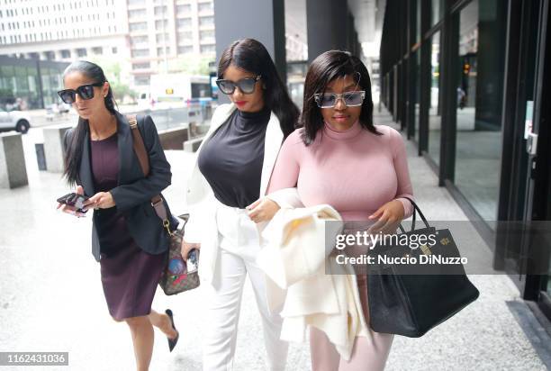 Supporters of singer R. Kelly, Azriel Clary and Joycelyn Savage, leave after the singer's arraignment at the Dirksen Federal Building on July 16,...