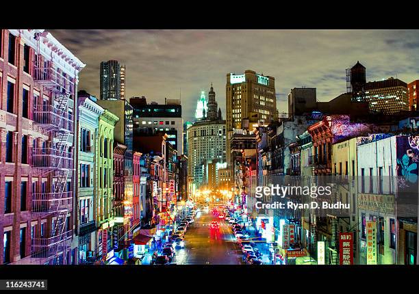 urban rainbow: east broadway at night - broadway manhattan stock pictures, royalty-free photos & images