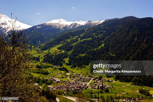 the city of châbles inside the mountains as seen from verbier - verbier ストックフォトと画像