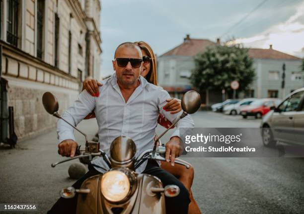 a couple goes on holiday with their scooter - couple scooter stock pictures, royalty-free photos & images