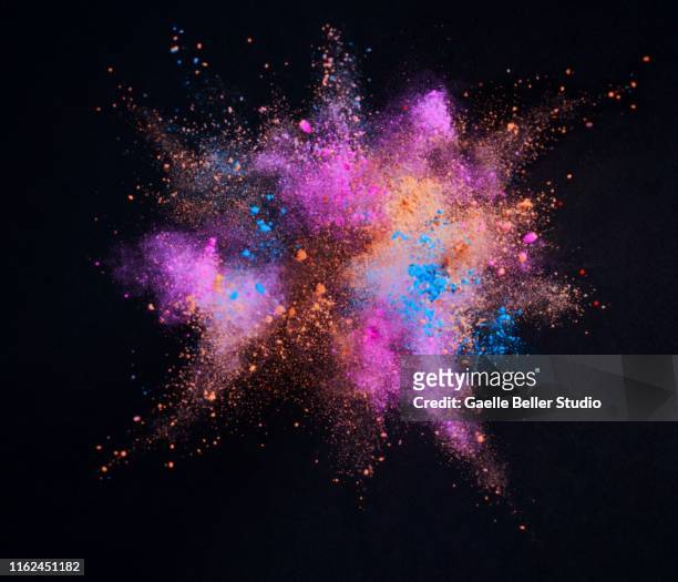 colorful powders explosion - orange powder stock pictures, royalty-free photos & images