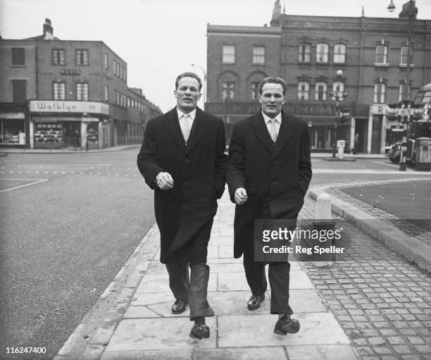 British boxer Henry Cooper and his twin brother George , arriving for a training session at the Thomas a Becket gym on the Old Kent Road, South...