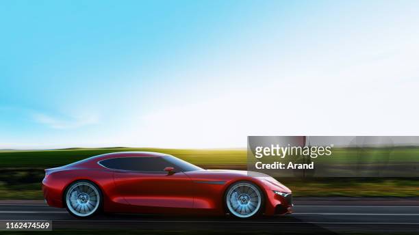 red car driving on a road - luxury sports car stock pictures, royalty-free photos & images