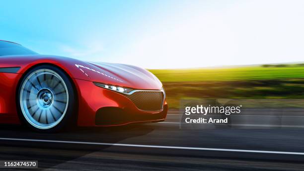 red car driving on a road - red porsche stock pictures, royalty-free photos & images
