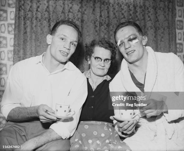 British boxer Henry Cooper with his twin brother George , and their mother Lily at their home in Bellingham, south London, 13th January 1959. Henry...